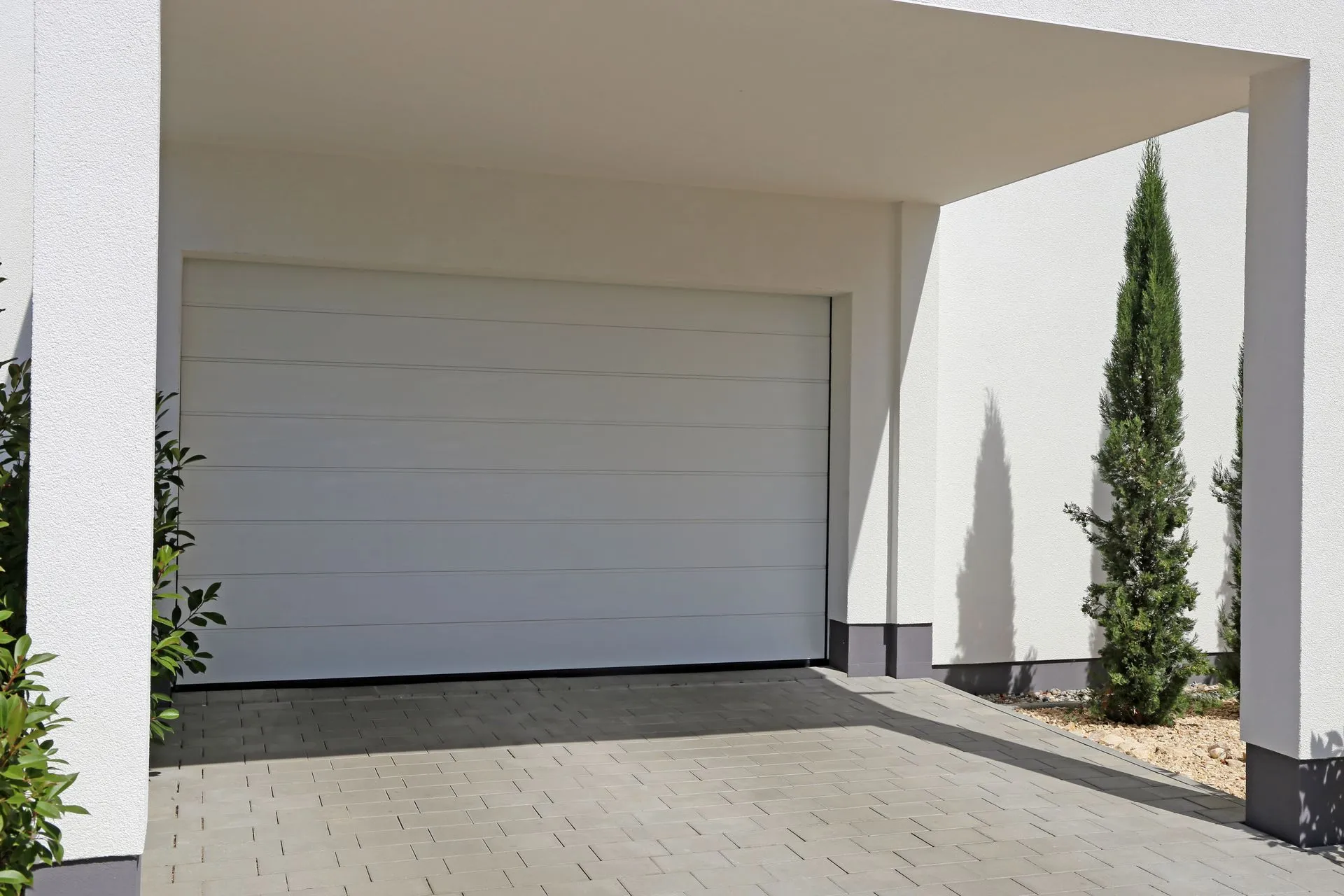 A white garage door with a canopy over it